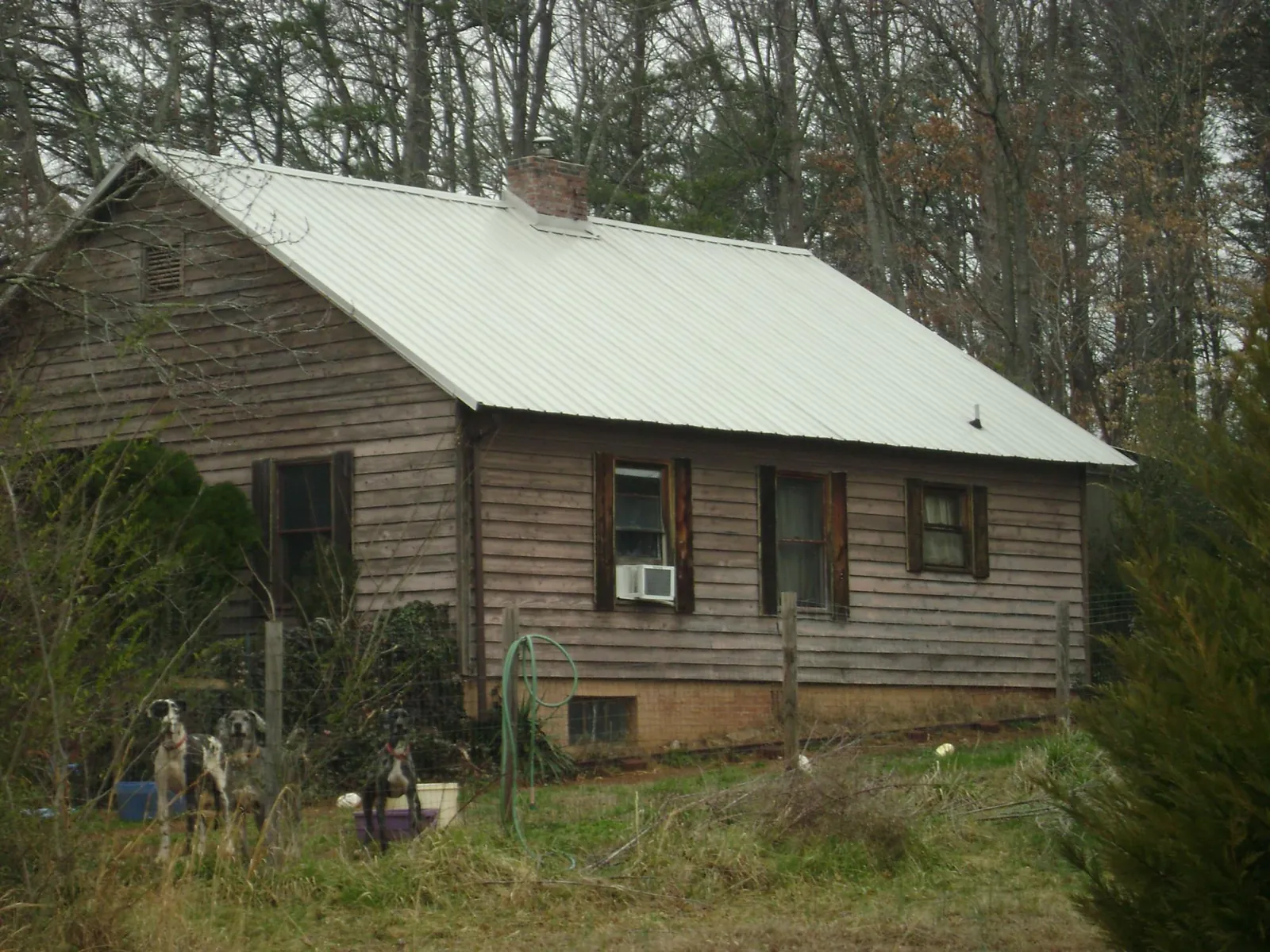 White metal roof on an old wood sided farmhouse, from a Metal Roof Installation job in West Rutland